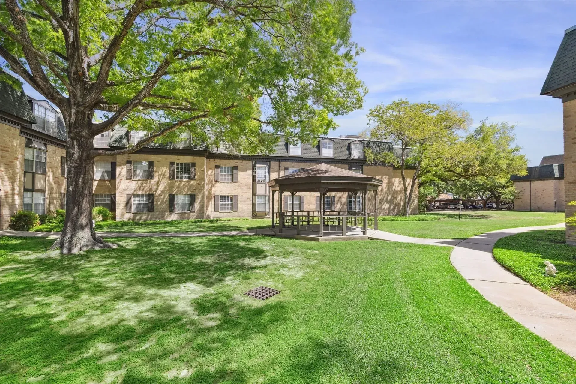 Green grass and gazebo in courtyard at Treemont Senior Community in Houston, Texas