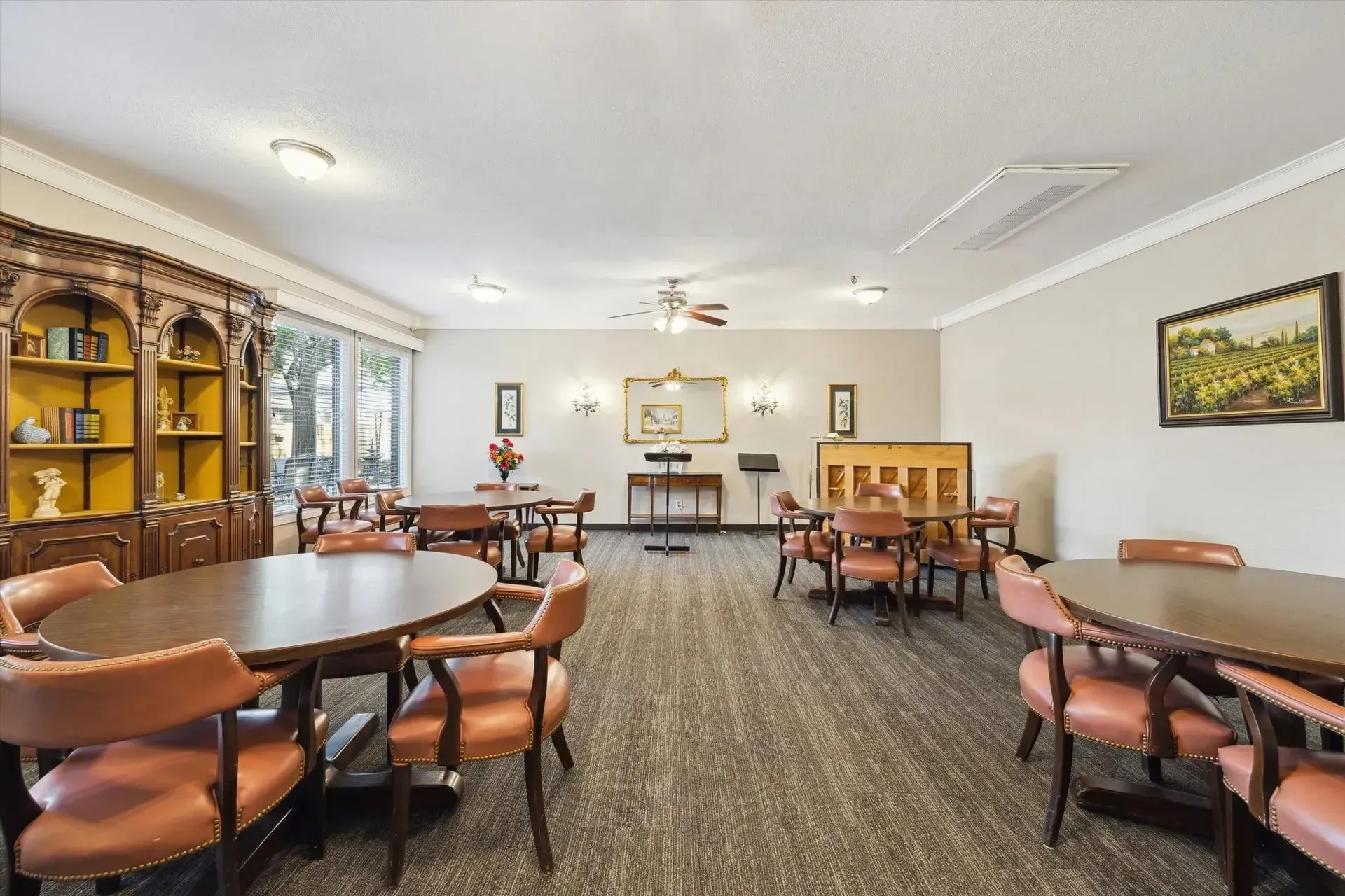 Brown chairs around circular tables at Treemont Senior Community in Houston, Texas
