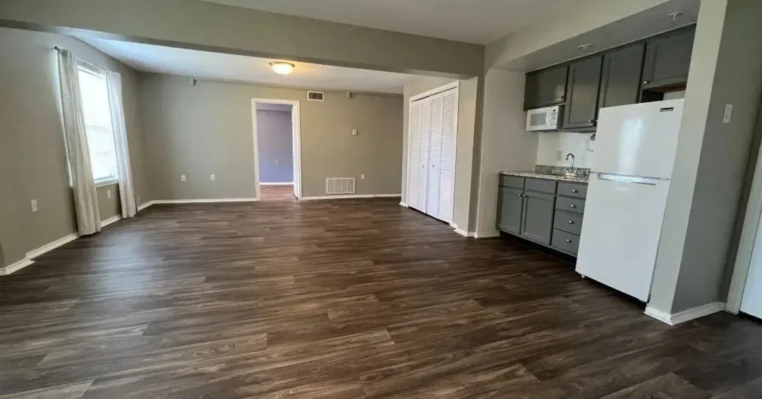 Open living area with kitchen appliances at Treemont Senior Community in Houston, Texas