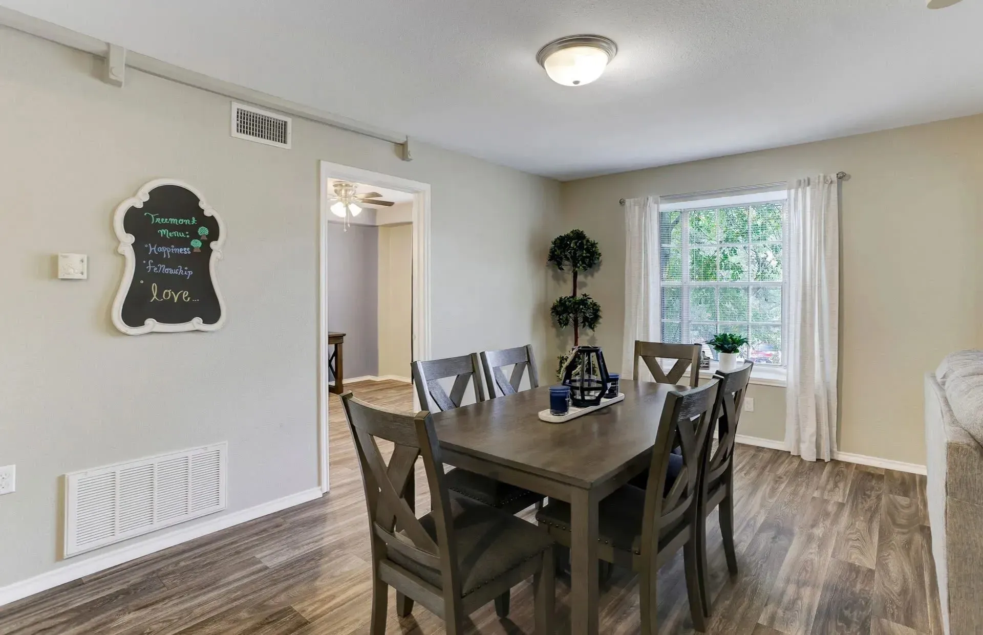 Dining table with chairs and window view at Treemont Senior Community in Houston, Texas