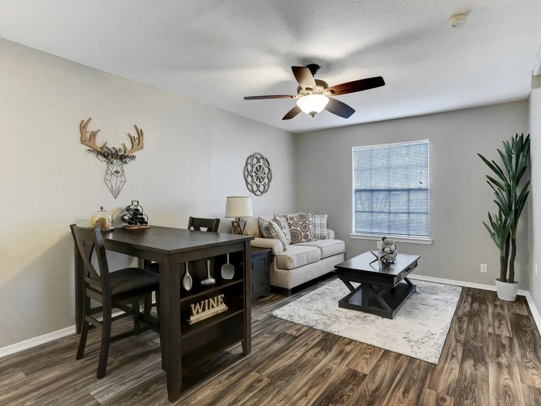 Dining table with two chairs and decor at Treemont Senior Community in Houston, Texas