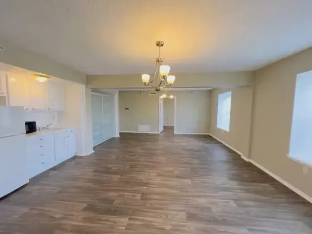 Wooden flooring with white cabinetry at Treemont Senior Community in Houston, Texas