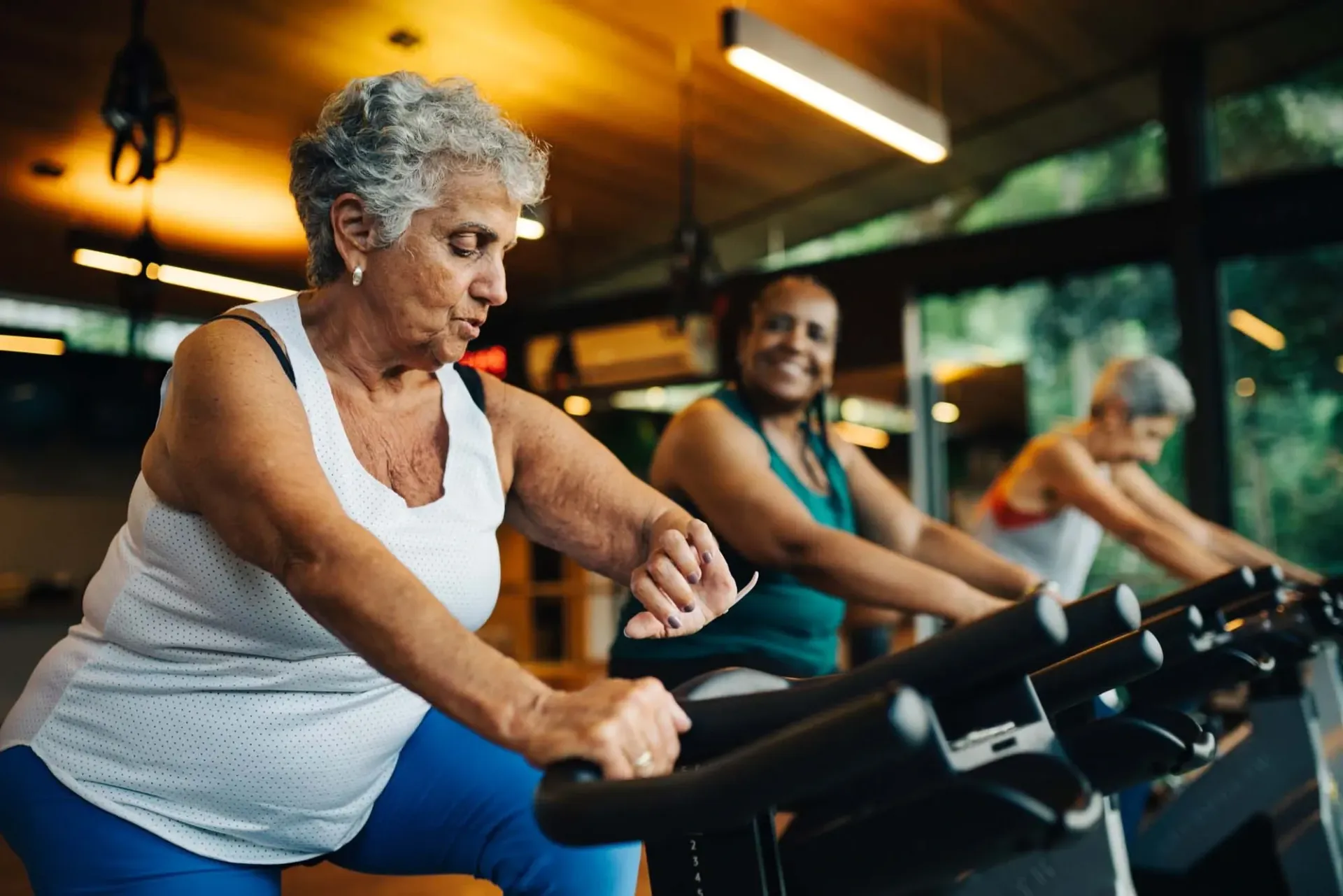 Older woman exercising on a machine at Treemont Senior Community in Houston, Texas