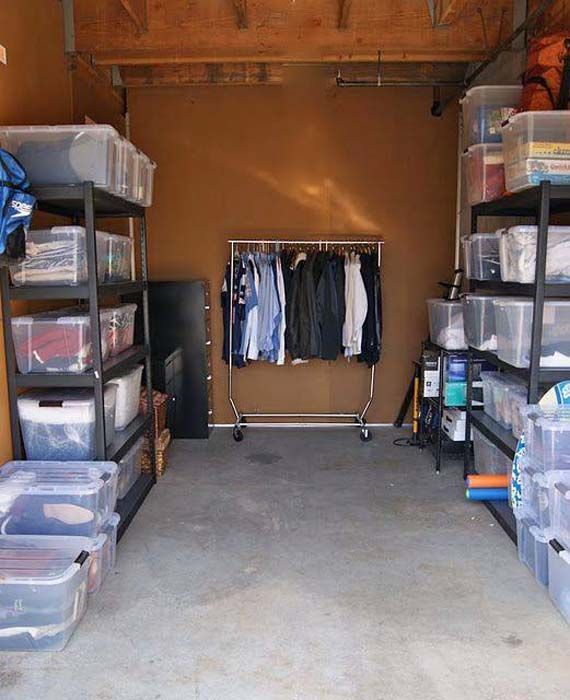 Garage interior with clothing rack and storage bins on shelves.