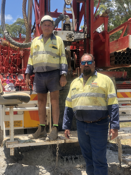 Two men in work clothes stand near drilling equipment outdoors — Kowaltzke Drilling Services in Gatton, QLD 