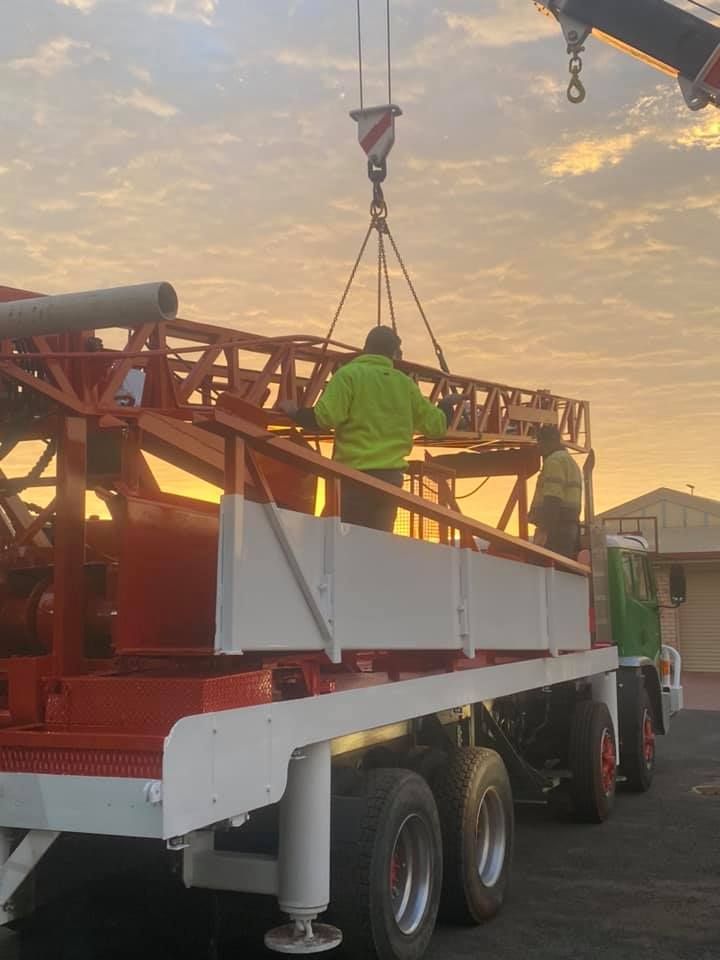 A Crane is Lifting a Ladder on Top of a Truck — Kowaltzke Drilling Services in Gatton, QLD