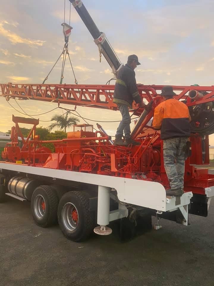 Two Men Are Working on a Crane on the Back of a Truck — Kowaltzke Drilling Services in Gatton, QLD