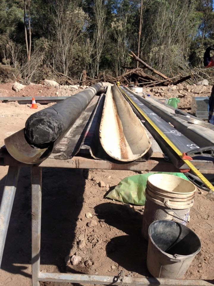 A Wooden Table With Buckets and Measuring Tape on It — Kowaltzke Drilling Services in Gatton, QLD