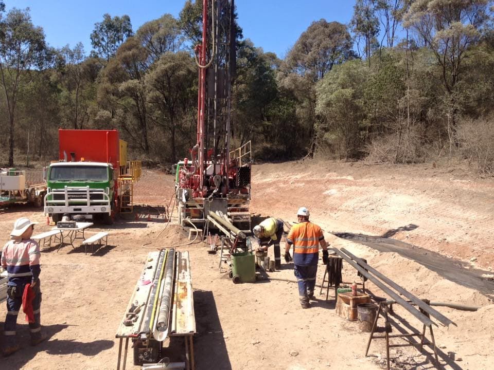 A Group of Construction Workers Are Working in a Dirt Field — Kowaltzke Drilling Services in Gatton, QLD
