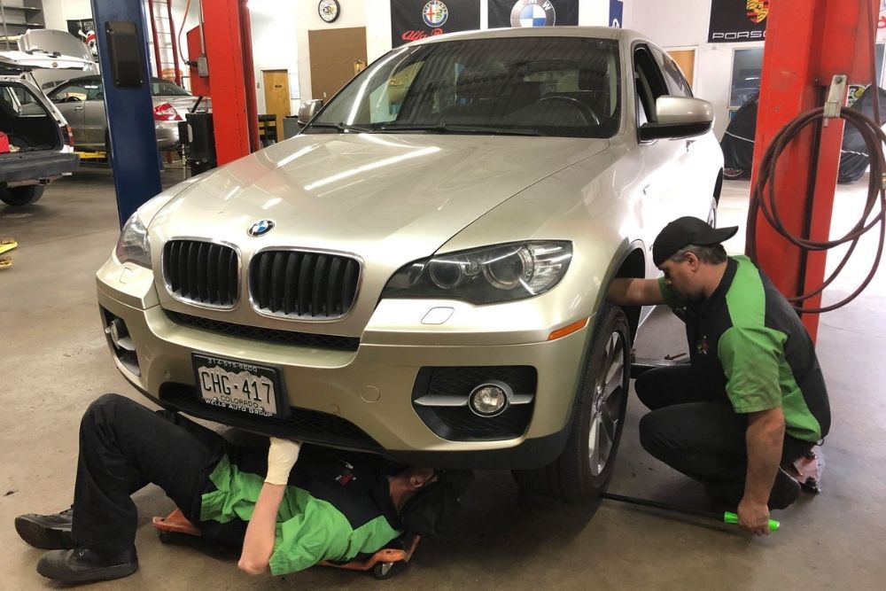 Our expert staff working on repairs for BMW car | AutoImports of Denver