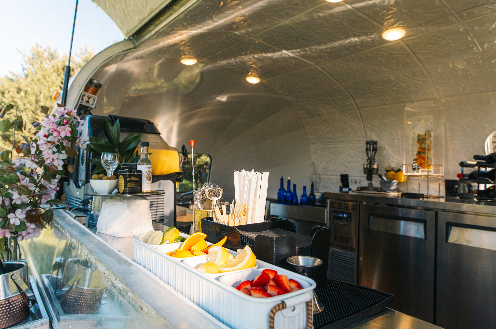 A kitchen with a tray of fruit on the counter.