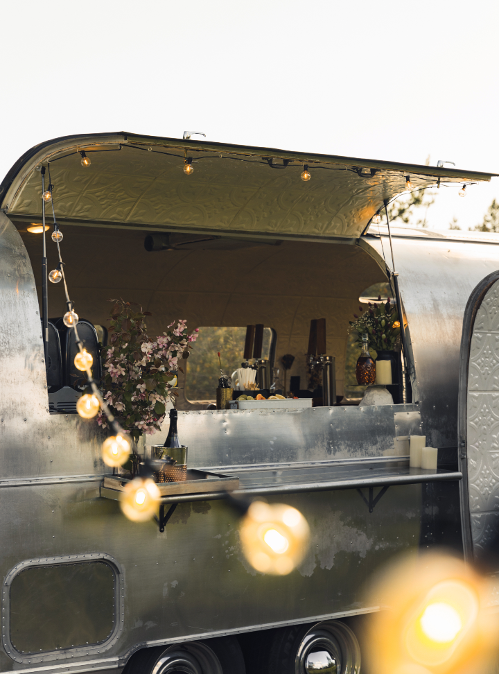 Airstream bar trailer with string lights at Whitefish event