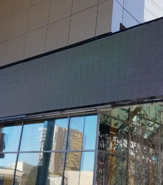 A building with a reflection of a building in the windows