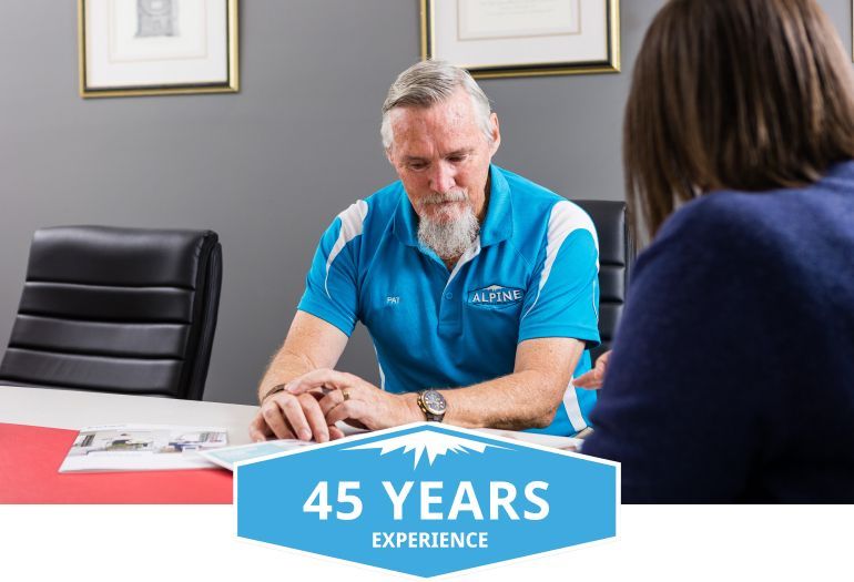 A man in a blue shirt is sitting at a table with a woman.