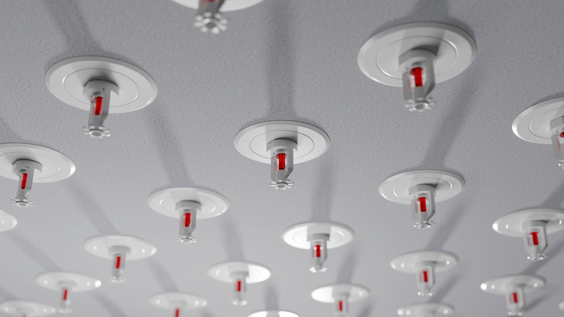 Multiple fire sprinkler heads are installed on the ceiling. Multiple fire sprinkler heads are installed on the ceiling.