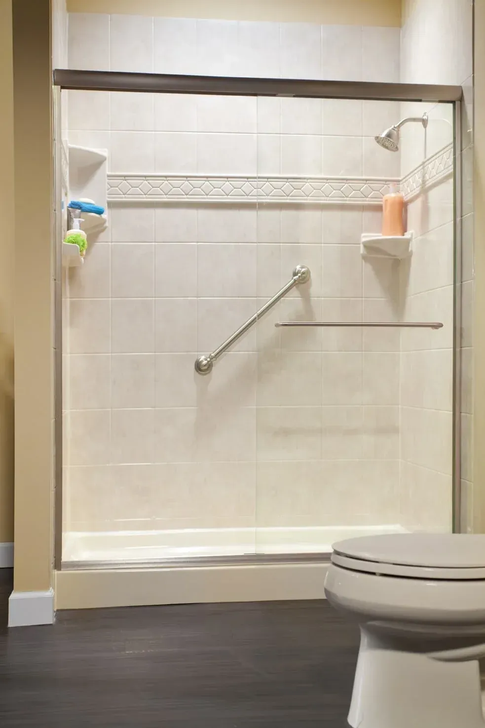 Modern bathroom with white sink, wooden vanity, bathtub shower, and light gray tile walls