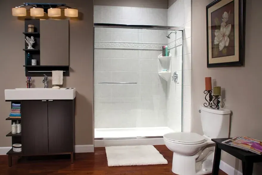 Modern bathroom with white marble-patterned bathtub and shower, brown textured shelves with lights, and a black vanity.