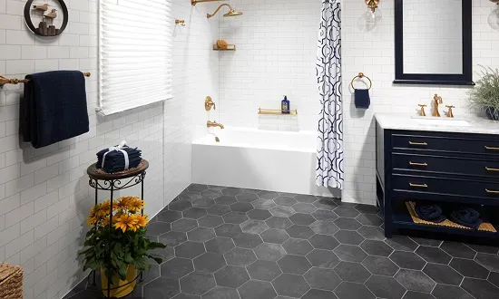 Modern gray bathroom with glass shower, vanity, toilet, and wood door