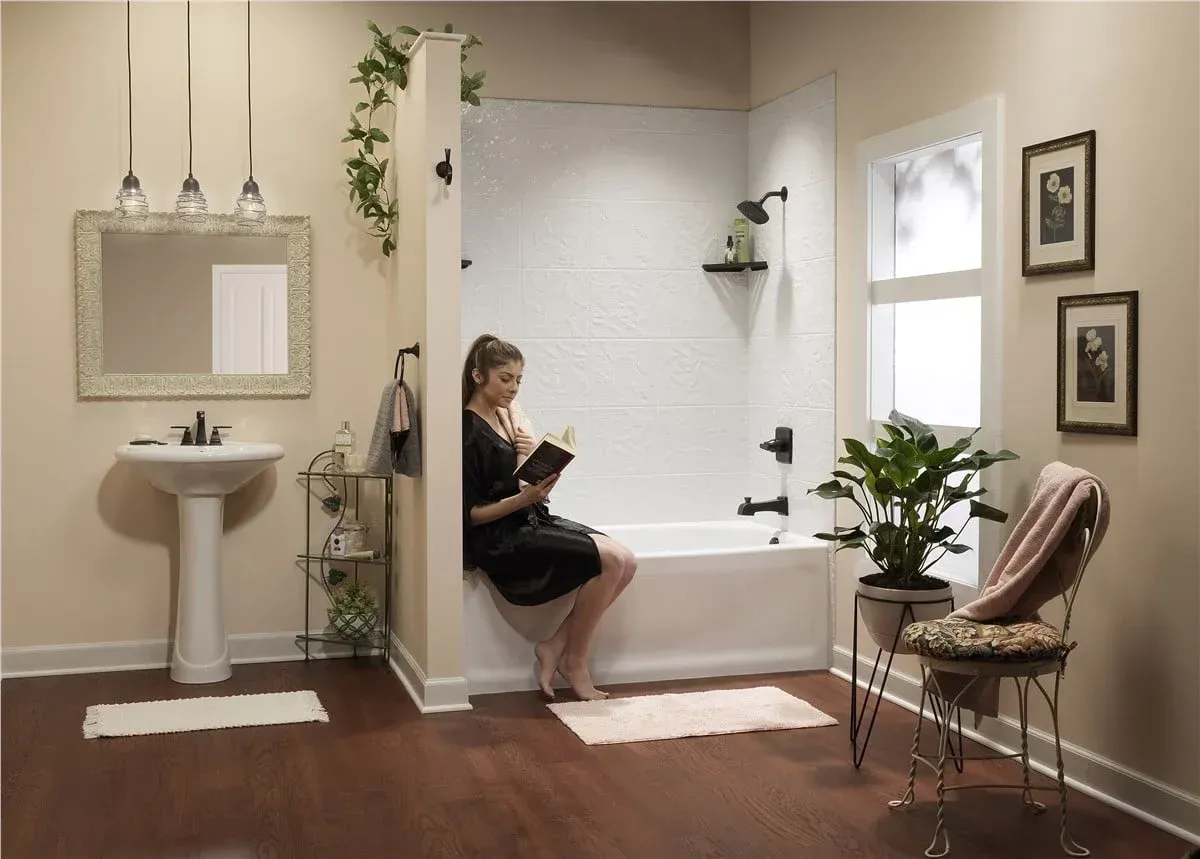White bathtub and shower alcove with built-in shelves and chrome fixtures