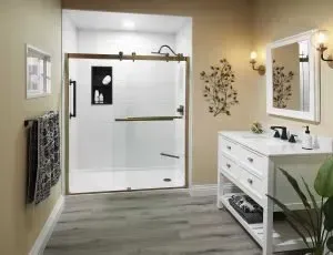 Modern bathroom featuring a sliding glass door walk-in shower with black fixtures and a white double-vanity sink.
