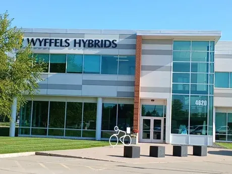Modern office building with glass facade and “Wyffels Hybrids” sign.