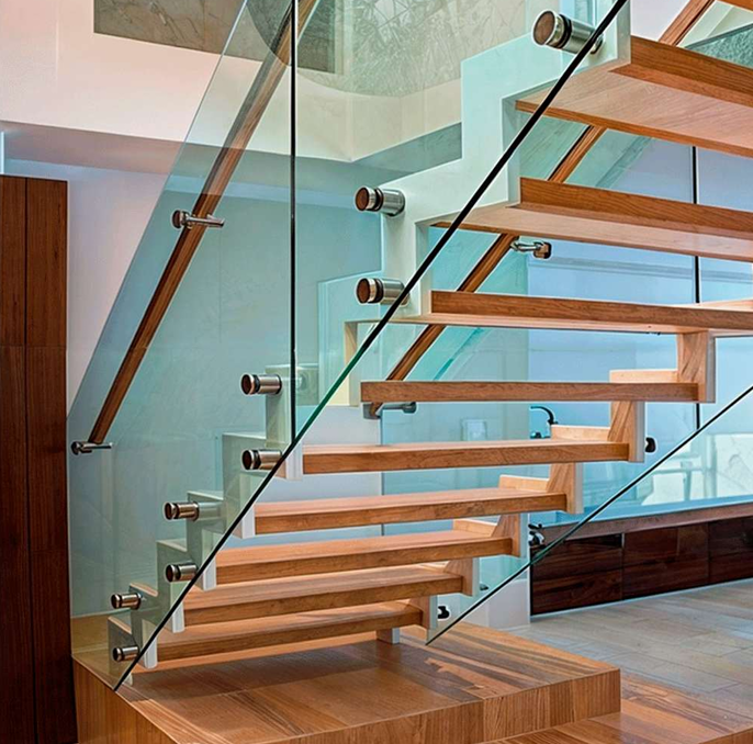 Wooden staircase with glass railing.
