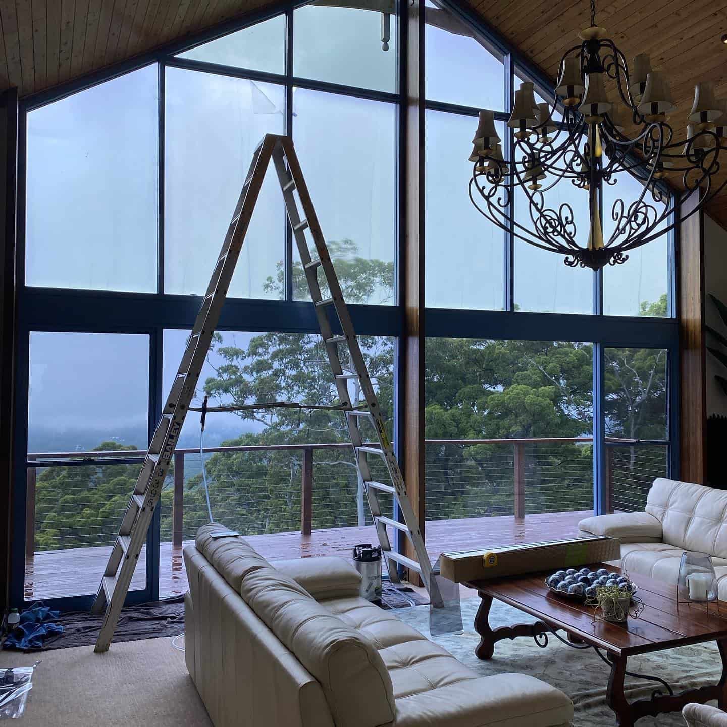 A Living Room With A Ladder And A Chandelier — Home Tint Sunshine Coast Window Tinting In Maroochydore, QLD