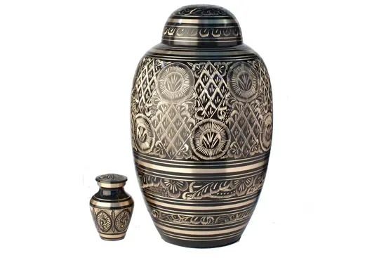 Ornate engraved metal vase with a smaller matching vase on a white background