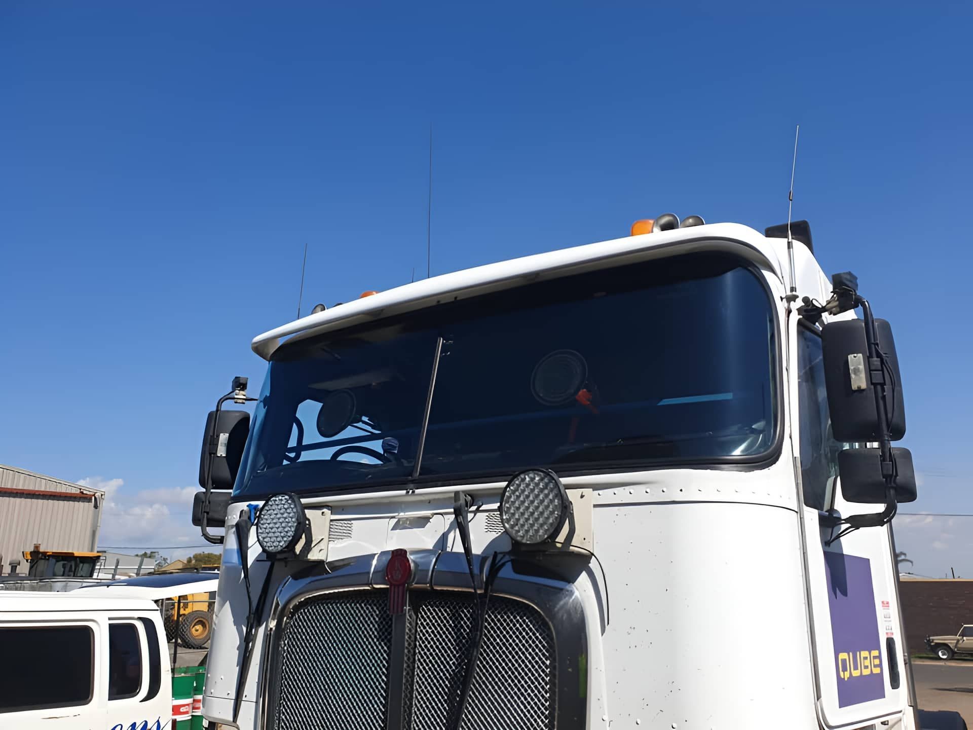 A White Truck Is Parked In A Parking Lot With A Blue Sky In The Background — Petrena Windscreens In Aubigny, QLD