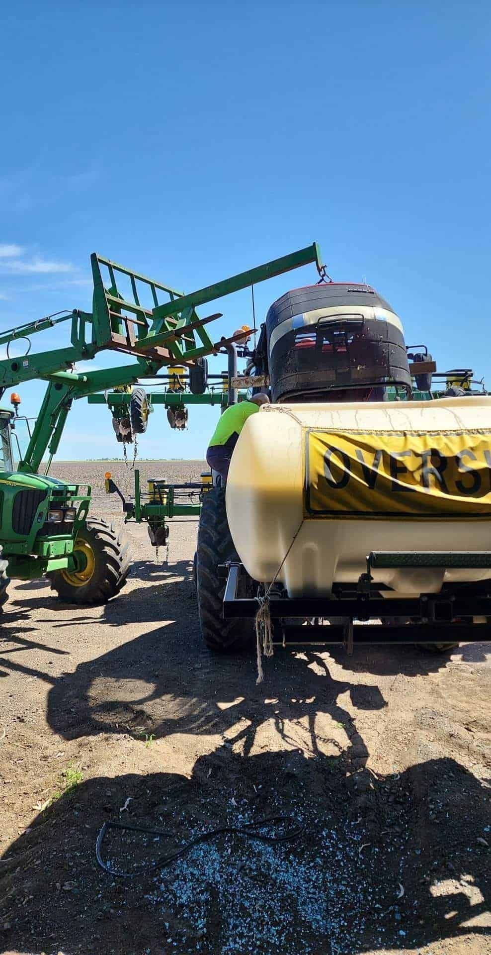 A Tractor With A Large Tank On The Back Is Sitting In A Field — Petrena Windscreens In Plainland, QLD