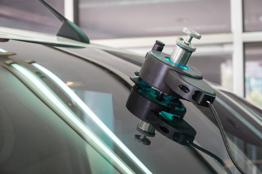 A Car Windshield Is Being Repaired With A Machine — Petrena Windscreens In Highfields, QLD