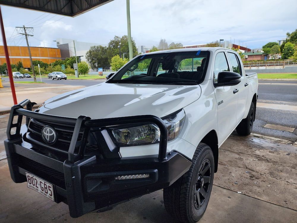 A White Truck With A Black Bumper Is Parked On The Side Of The Road — Petrena Windscreens In Toowoomba City, QLD