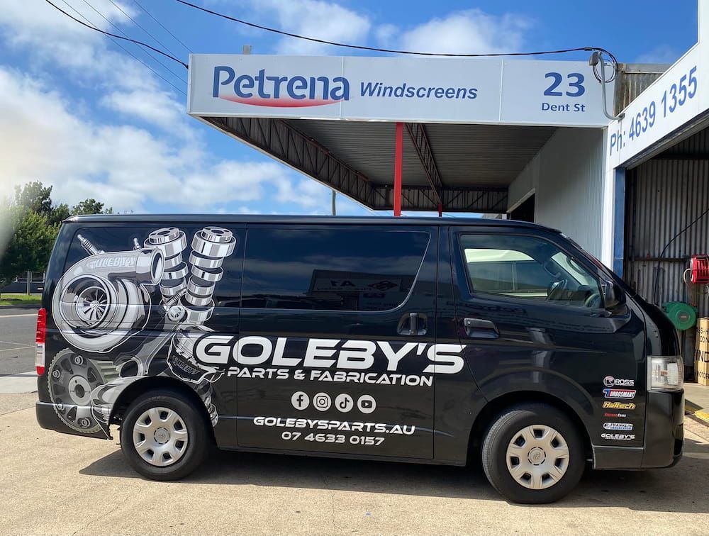A Black Van Is Parked In Front Of A Store — Petrena Windscreens In Meringandan, QLD