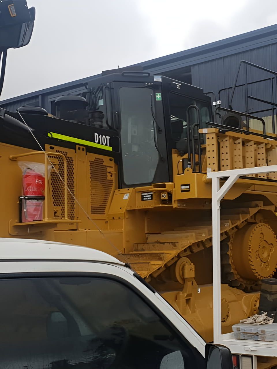 A Bulldozer Is Parked Next To A White Truck — Petrena Windscreens In Toowoomba City, QLD