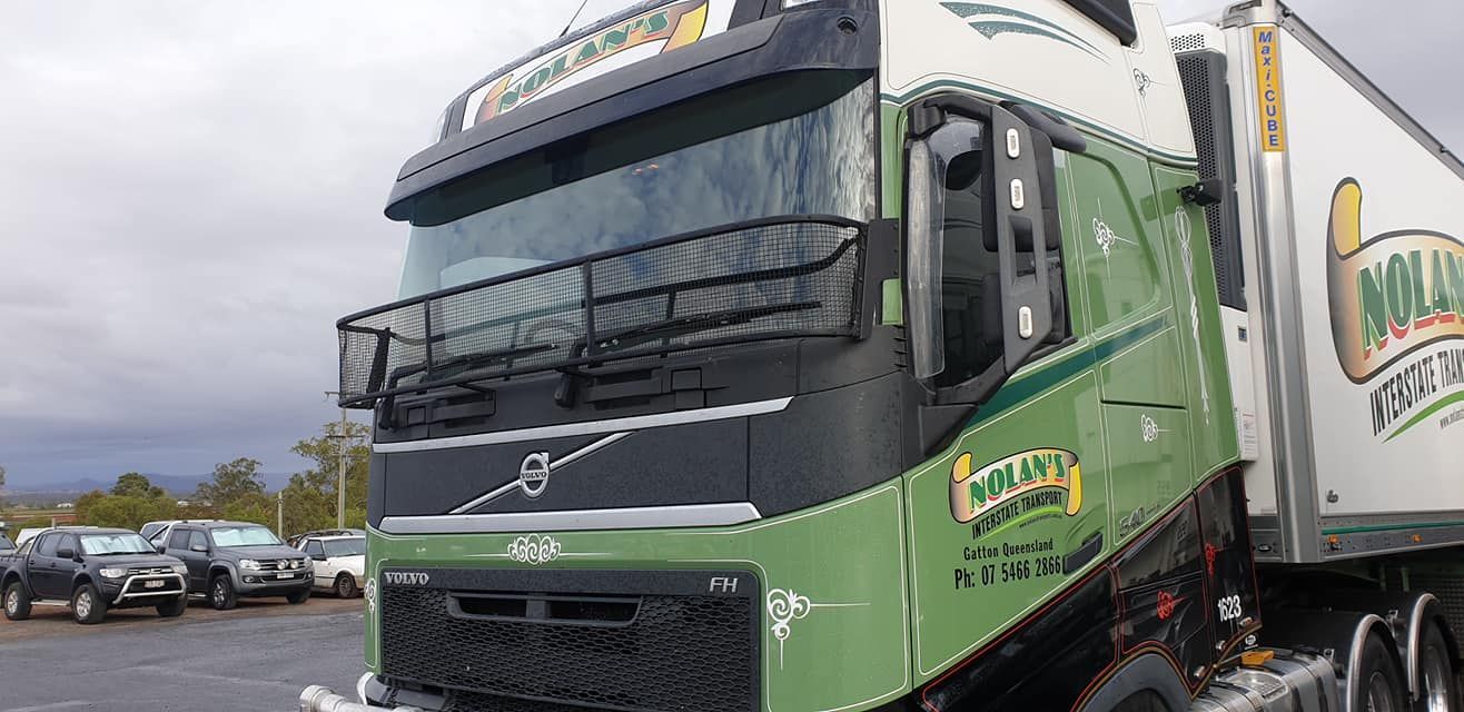 A Green And White Semi Truck Is Parked In A Parking Lot — Petrena Windscreens In Toowoomba City, QLD