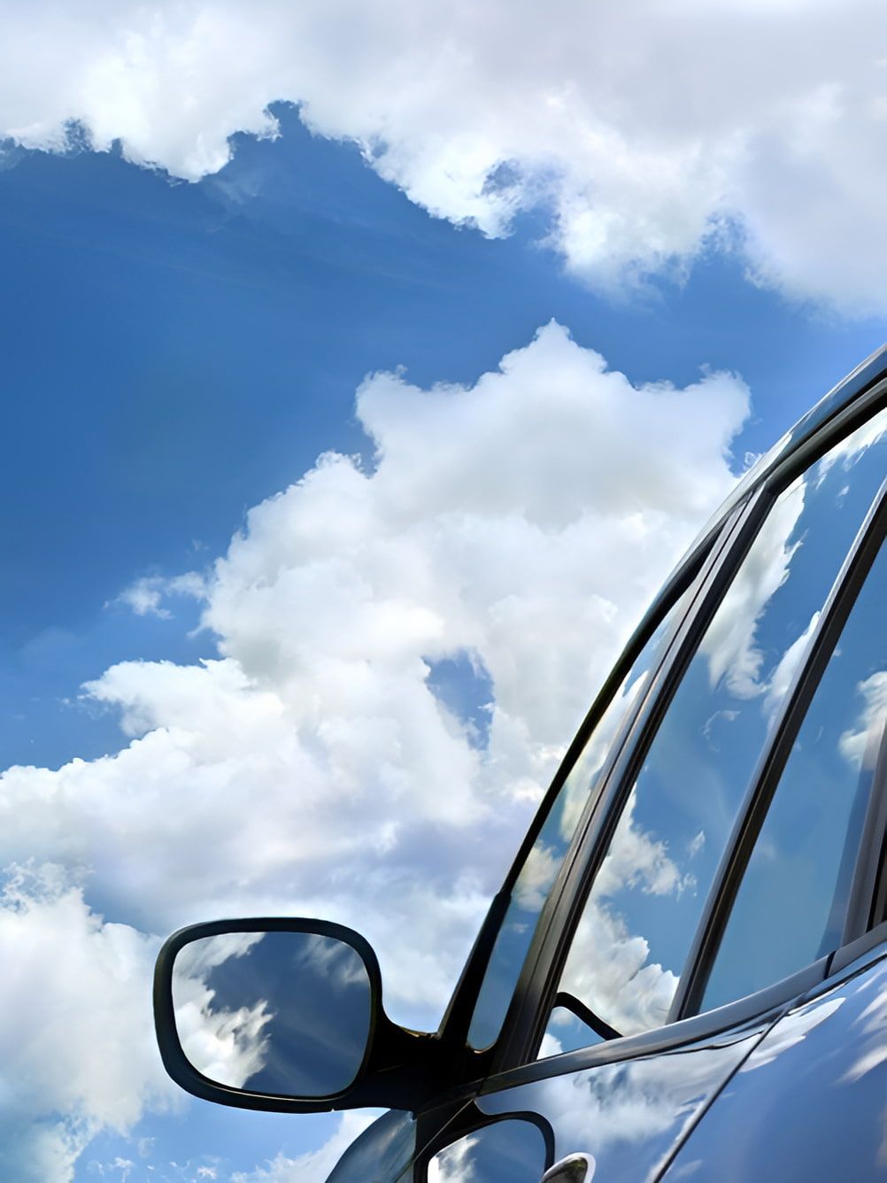 A Car Is Parked In Front Of A Blue Sky With Clouds — Petrena Windscreens In Toowoomba City, QLD