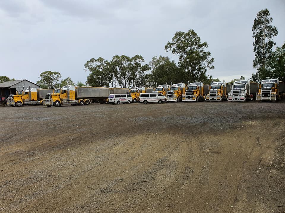 A Row Of Trucks Are Parked In A Gravel Lot — Petrena Windscreens In Plainland, QLD