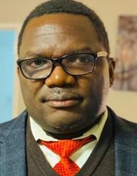 A man in glasses and a red tie