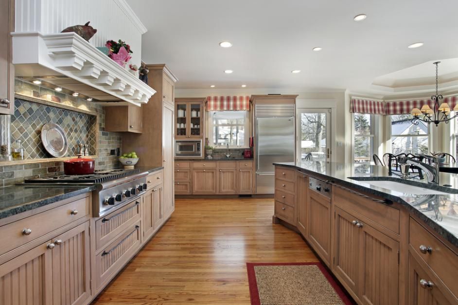 A large kitchen with wooden cabinets and granite counter tops