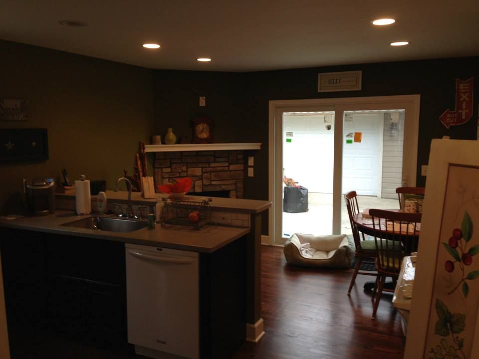 A kitchen with a sink , dishwasher , and sliding glass doors