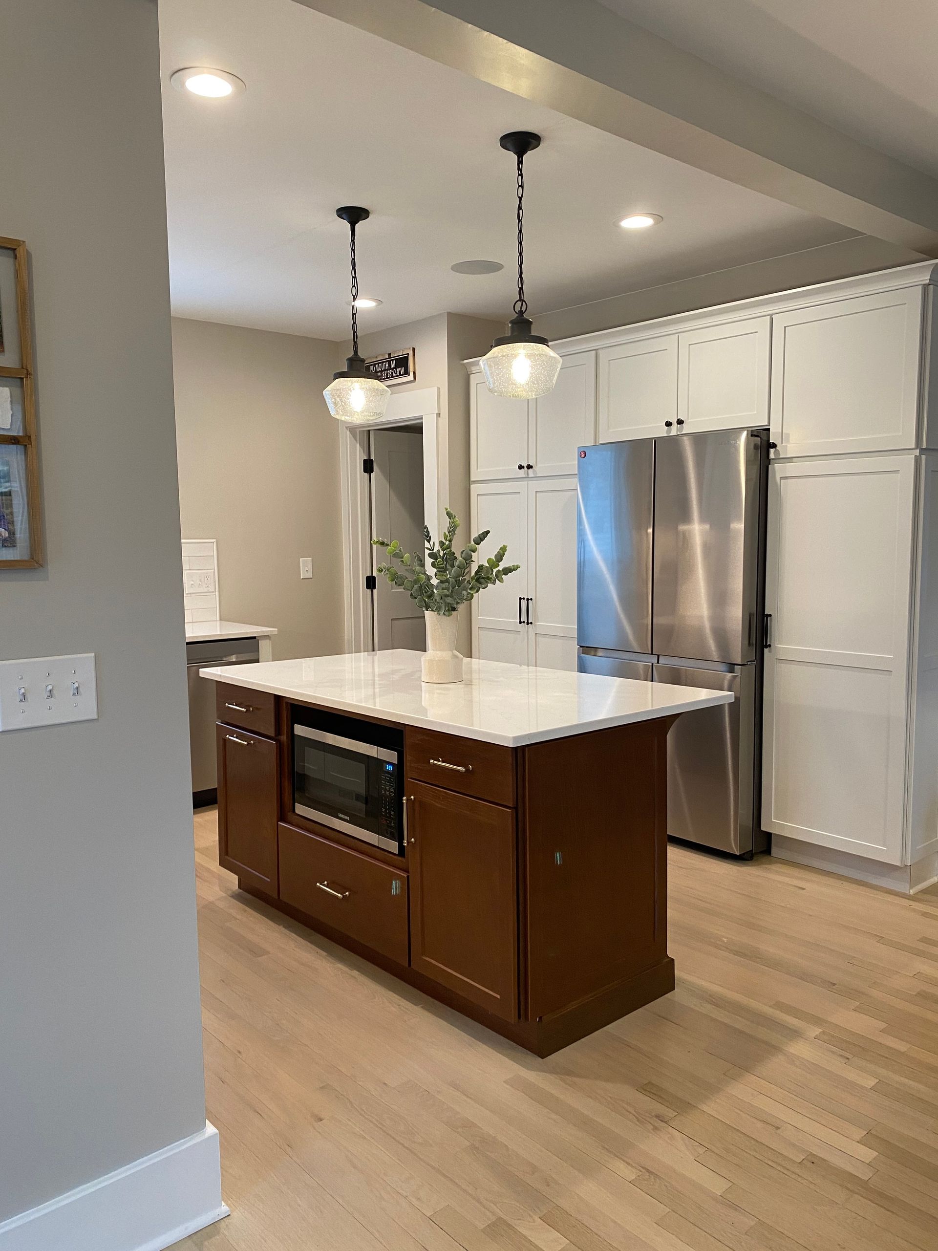 A kitchen with a large island and stainless steel appliances