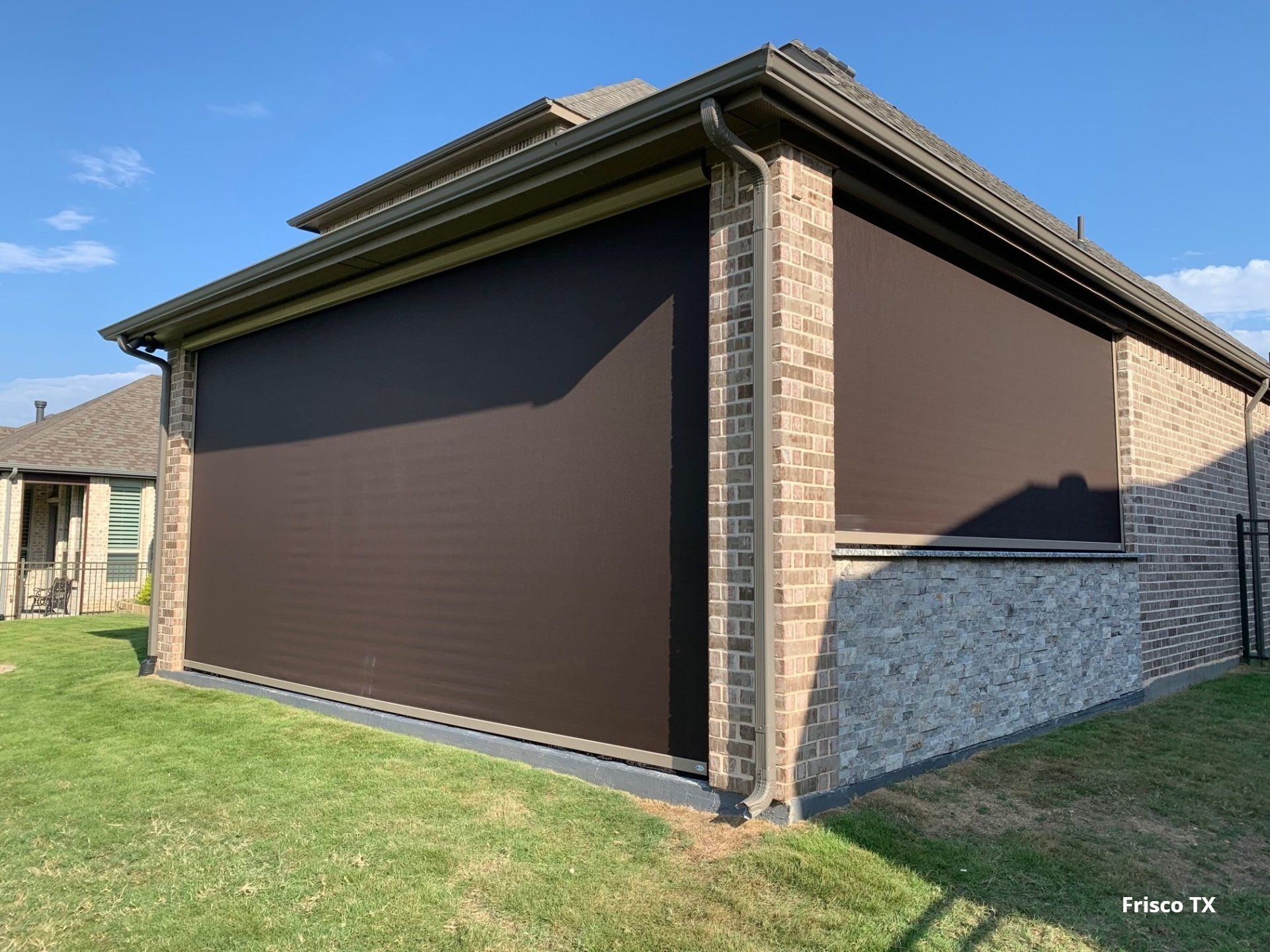 Shaded back patio with a motorized patio shade