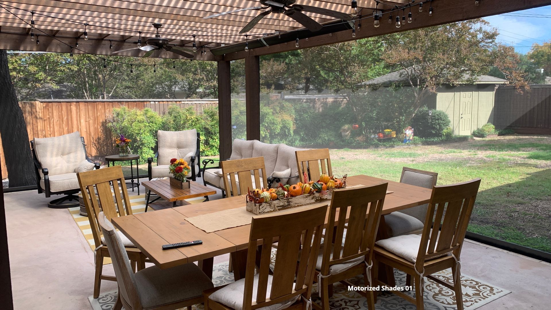 Outdoor dining furniture on a patio with retractable patio shades