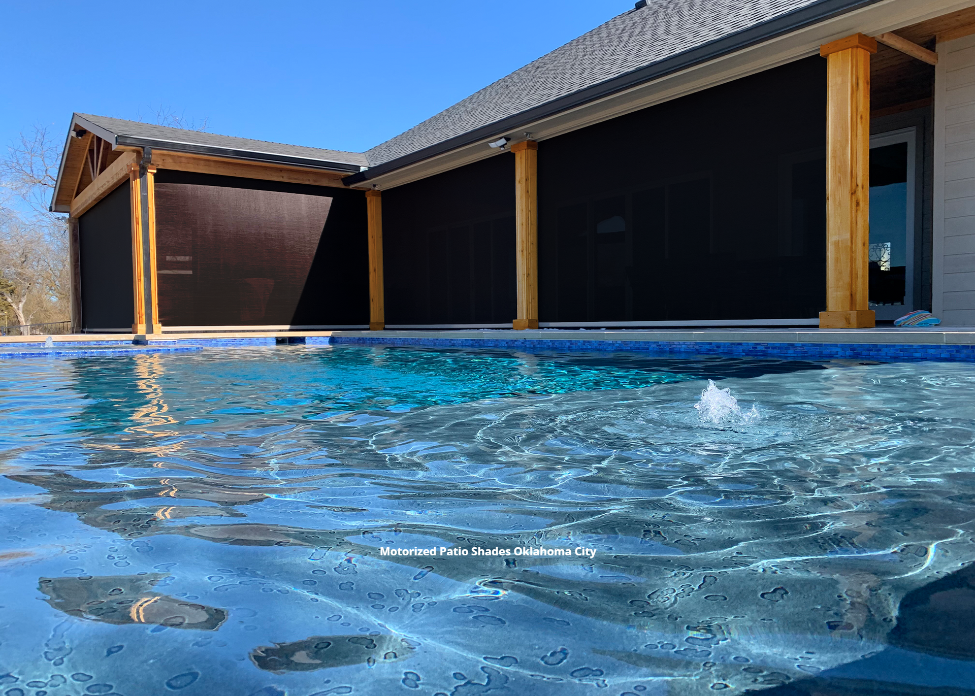 a picture of a pool with a motorized patio shade Oklahome City