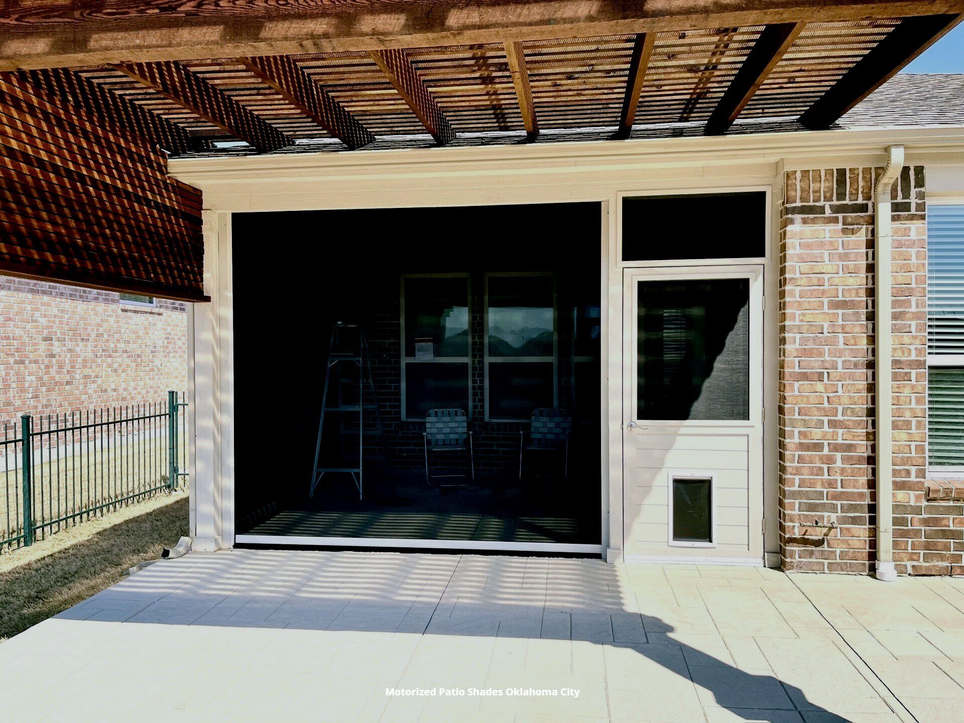 a picture of a screened in porch with motorized shades and a door with a doggie door oklahoma city
