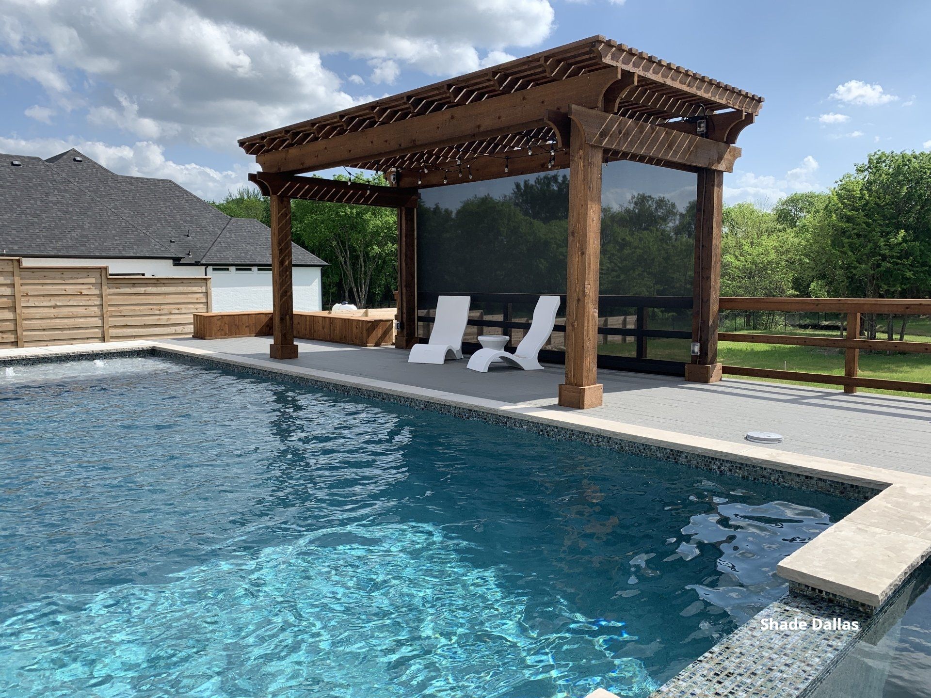 Retractable patio screen by the pool