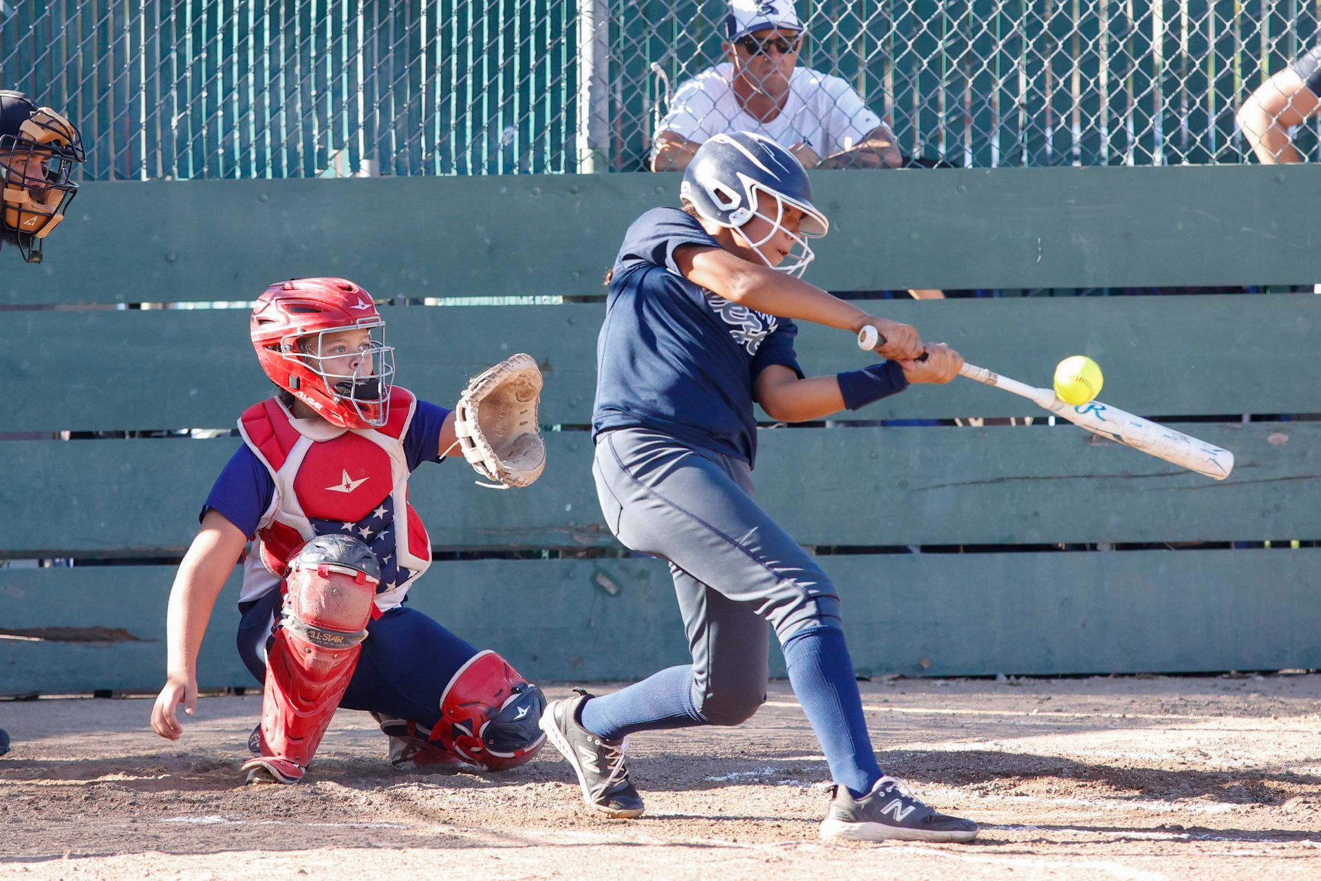 A baseball player is swinging a bat at a ball