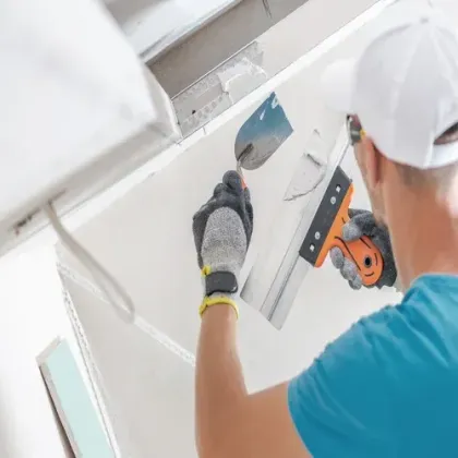 Sheetrock Tradesman and Professional Contractor preparing to apply the correct mixture of Mud to create a flawless drywall finishing