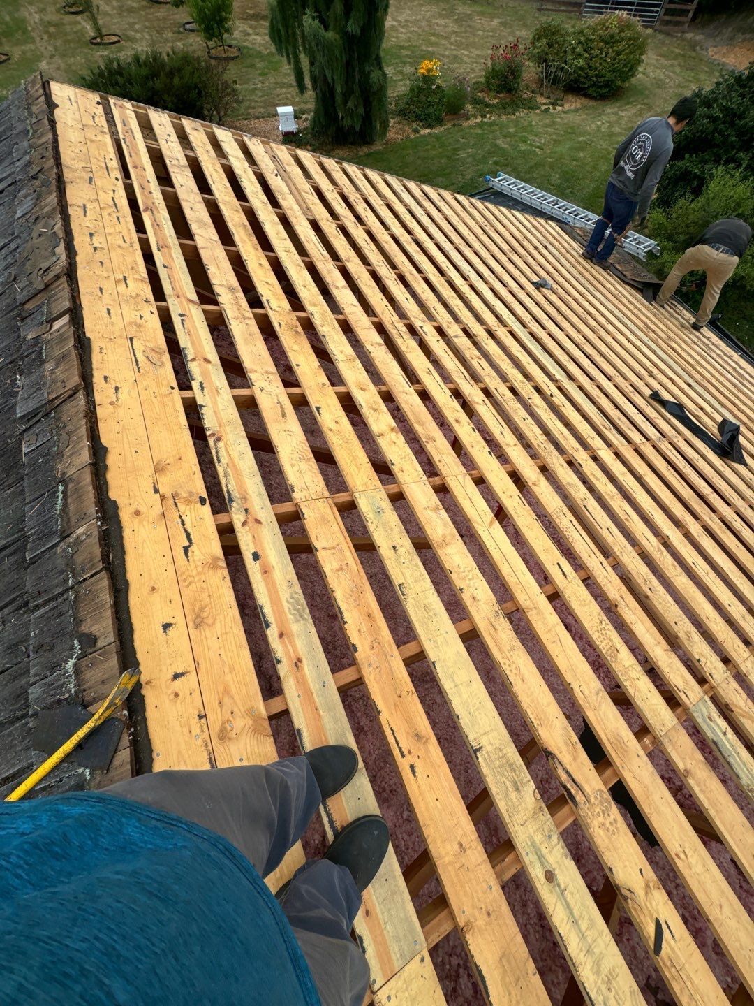Roof repair experts restoring a damaged roof in Yelm after severe weather.