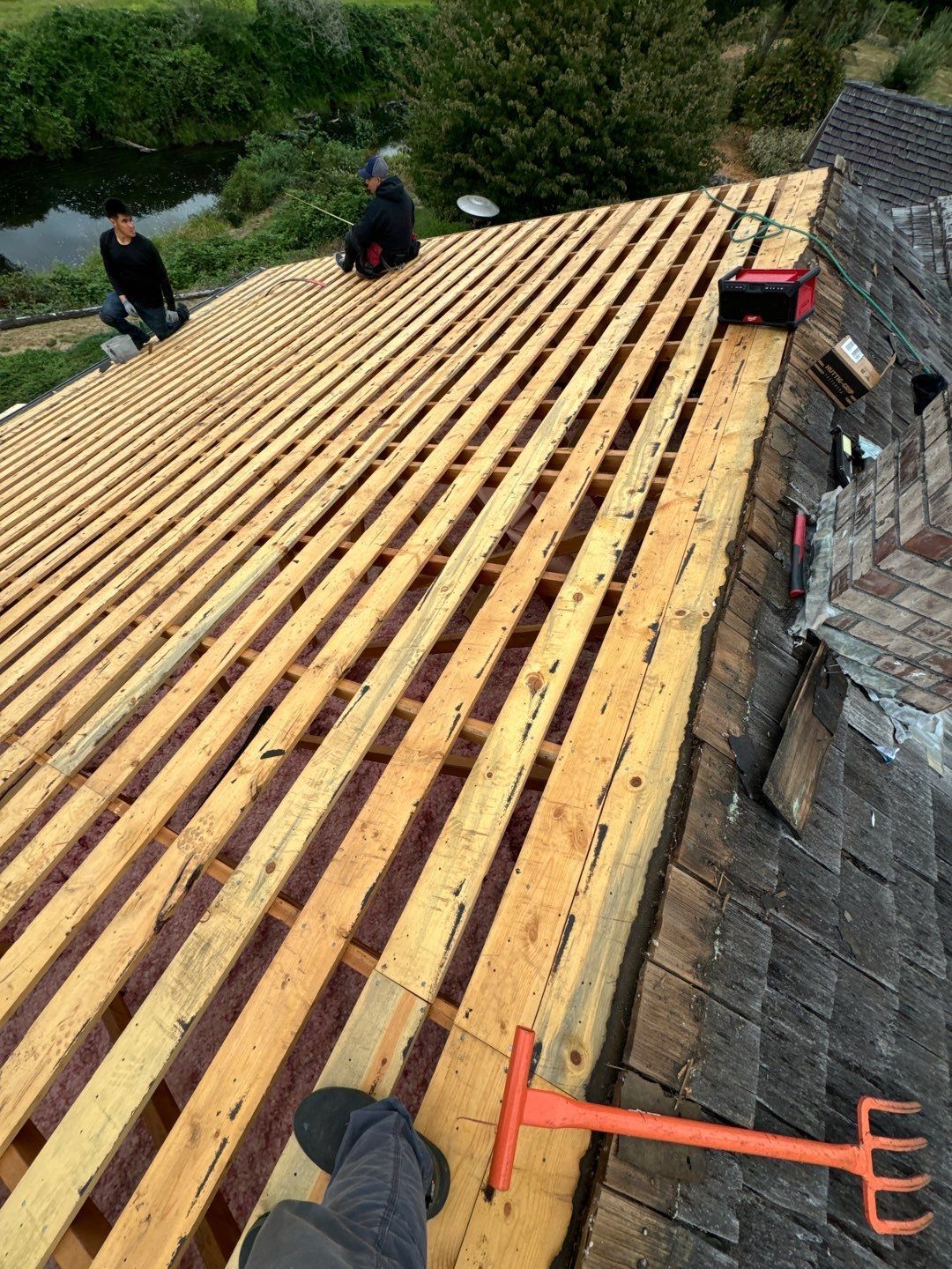 Roof repair experts restoring a damaged roof in Yelm after severe weather.